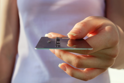 Saldi 2025: il vademecum per viverli al meglio e… sopravvivere! 6 Una donna mostra una carta di credito.
